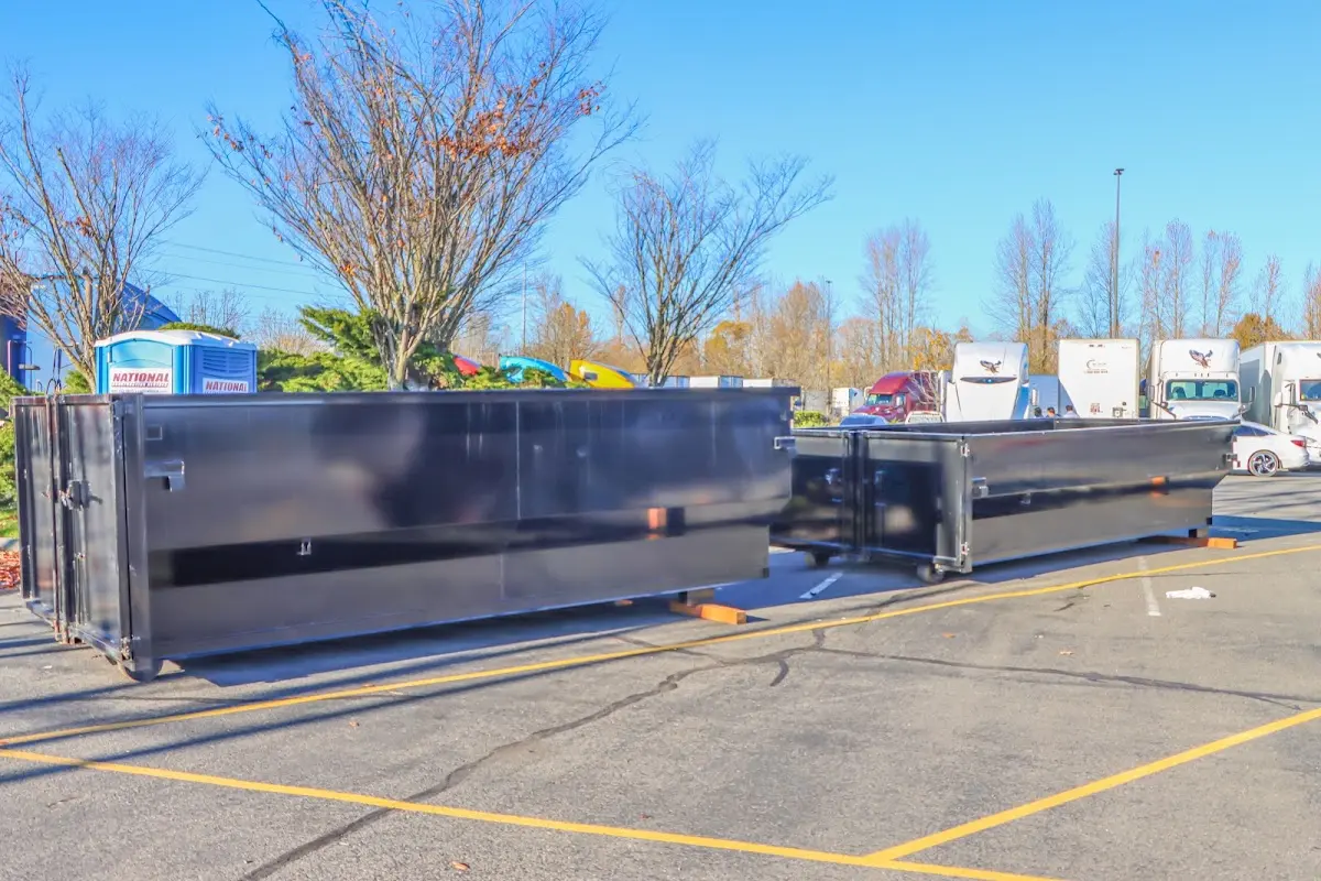 Professional dumpster rental service with roll-off container on residential driveway in Wright